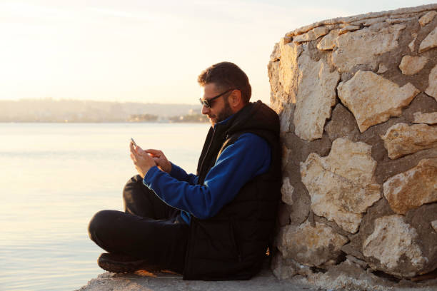 istock Mobile smartphone in man's hands near the sea 867534356