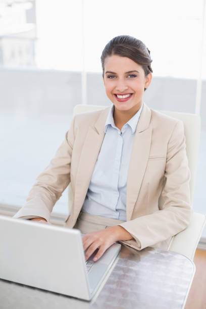 istock Happy smart brown haired businesswoman using a laptop 867543798