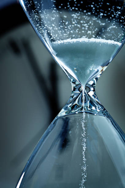 istock Deadline and Out of Time: Sand Timer Hourglass and Clock at Midnight 867550596