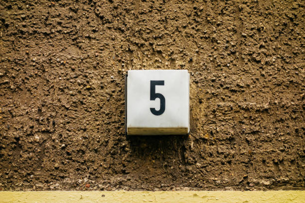 istock number 5 door sign on brown facade 867550880