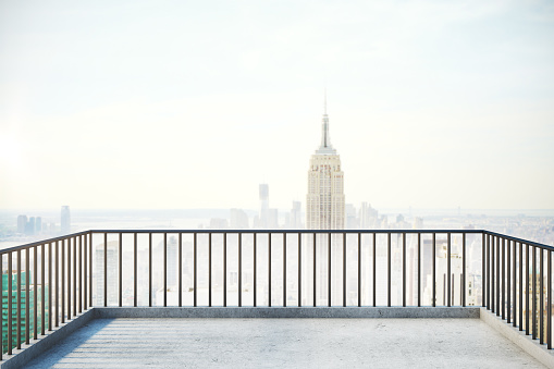 Balcony with railing and foggy New York city view with copy space. 3D Rendering