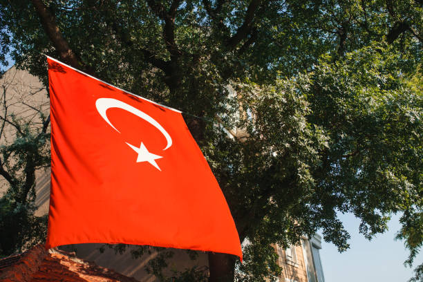 istock Turkish flag on the building next to the trees 867554104