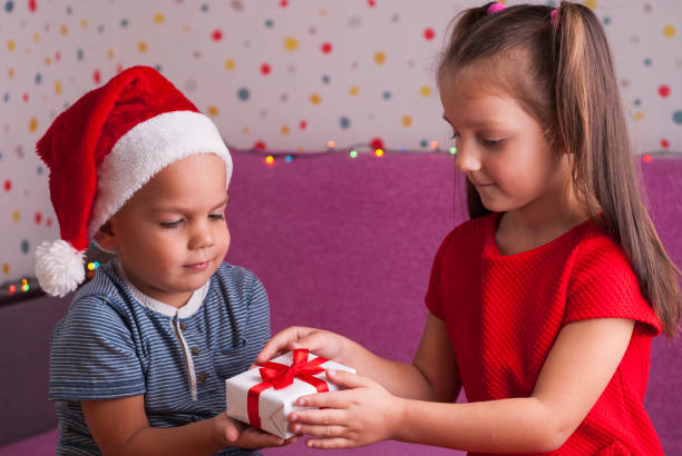 istock boy gives a gift to his sister 867556836