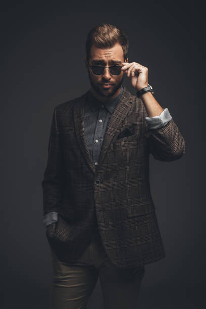 istock Man in suit looking over sunglasses 867557402