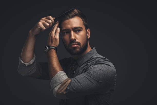 istock Handsome man grooming hair 867557620