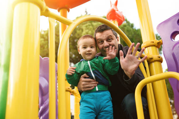 istock Father and son enjoying an outdoor playground 867559966