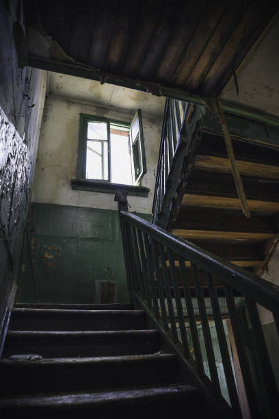istock Dark grim wooden stairs in old abandoned building 867566368