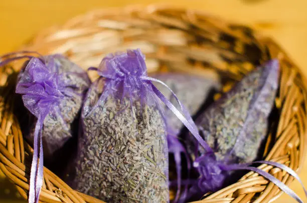 Small sacks with dried lavender. Dry lavender flower in sack in a wooden basket
