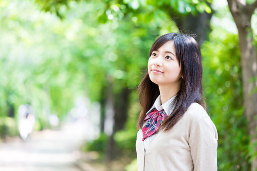 portrait of asian school girl in park