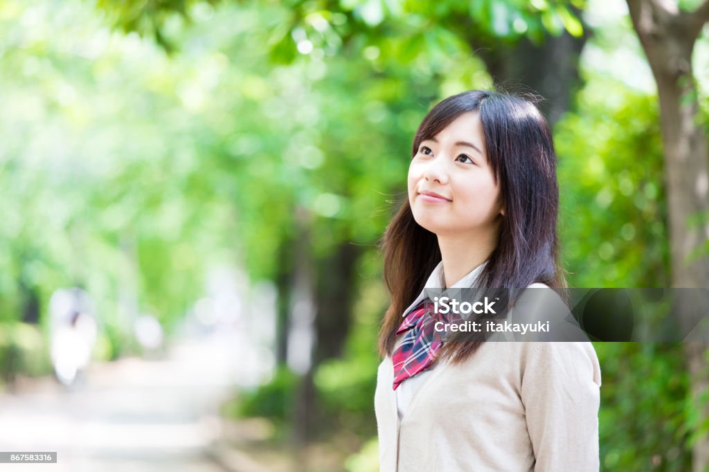 portrait of asian school girl in park Female High School Student Stock Photo