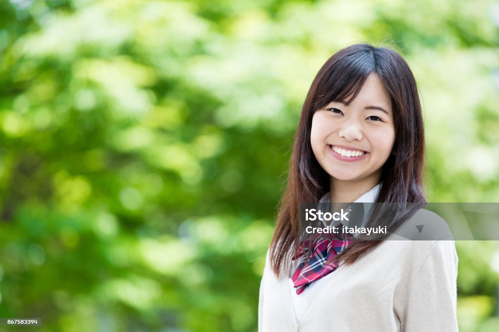 portrait of asian school girl in park Japanese Ethnicity Stock Photo