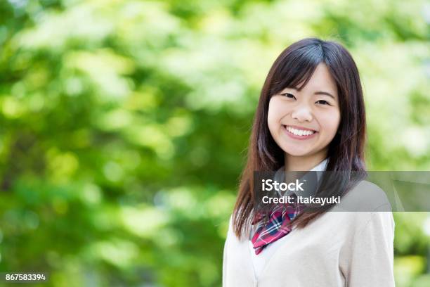 Portrait Of Asian School Girl In Park Stock Photo - Download Image Now - Japanese Ethnicity, Female High School Student, High School Student