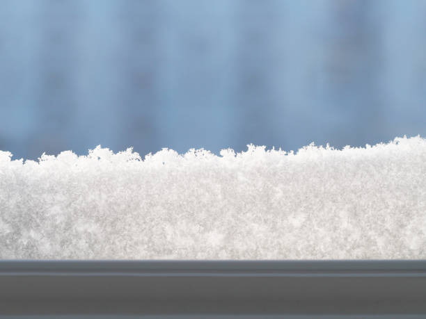 istock View from the window covered with snowflakes.Snow covered window. Snowdrift. Winter background. Abstract winter backdrop. 867598848