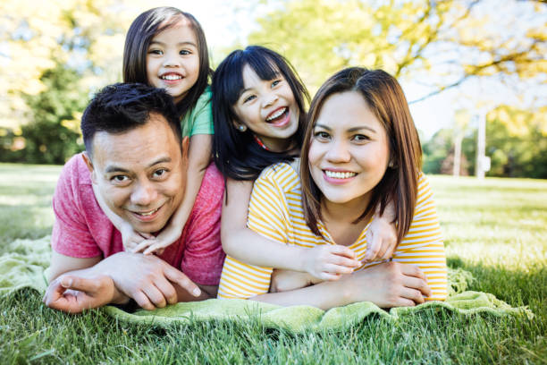 Happy family of four Two parents and two kids happy filipino family stock pictures, royalty-free photos & images