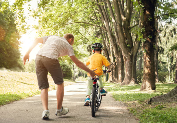 istock Father learn his little son to ride a bicycle 867612354