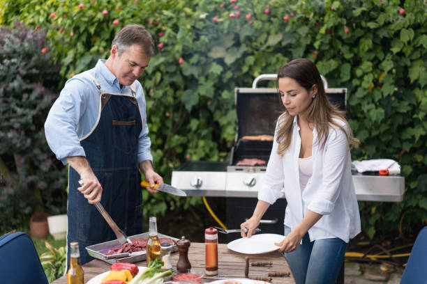 istock Happy couple making a BBQ at home 867612730