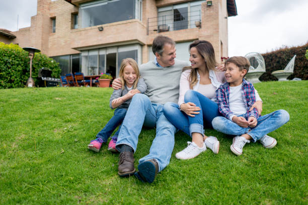 Portrait of a happy family having fun outdoors in front of their house - lifestyle concepts