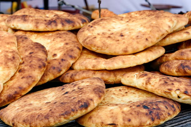 istock Hot and fresh baked flatbread on a frill for a picnic 867612932