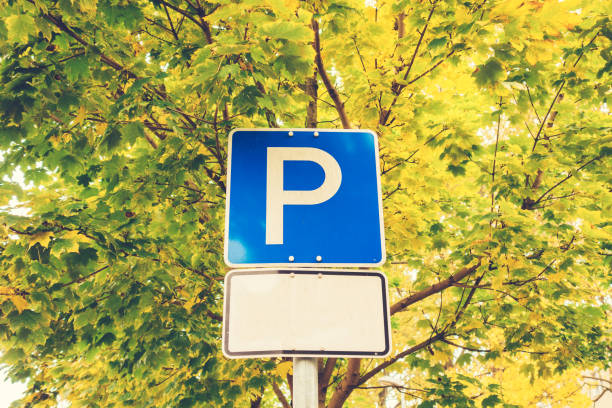 istock parking sign on beautiful autumn tree background 867631922
