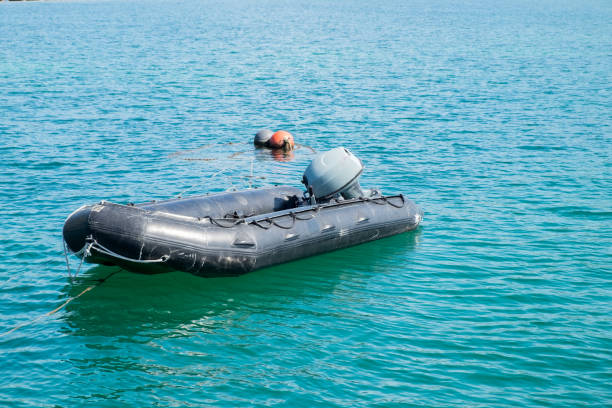 White rubber dinghy floating on a crystal sea