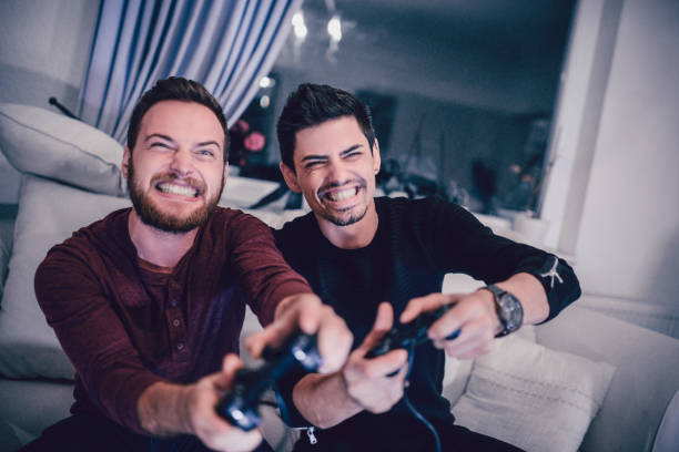 istock Two Excited Friends Playing Video Games 867637832
