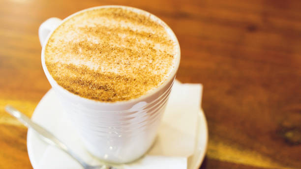 istock cappuccino cup on the brown wooden table 867641110