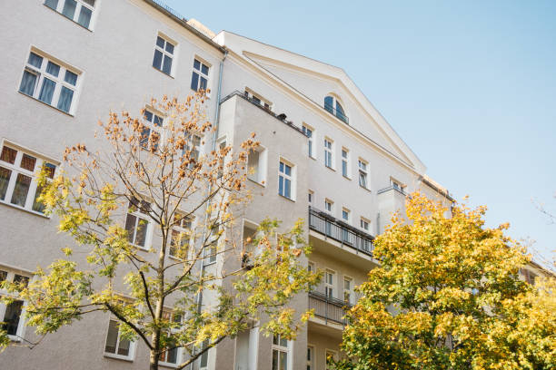 istock white residential building with yellow tree on the front side 867641296