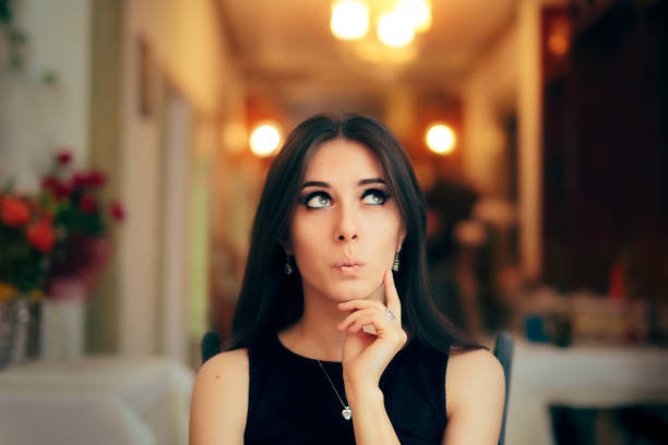 istock Cute Girl Thinking about Her Plan at Dinner Party 867642218
