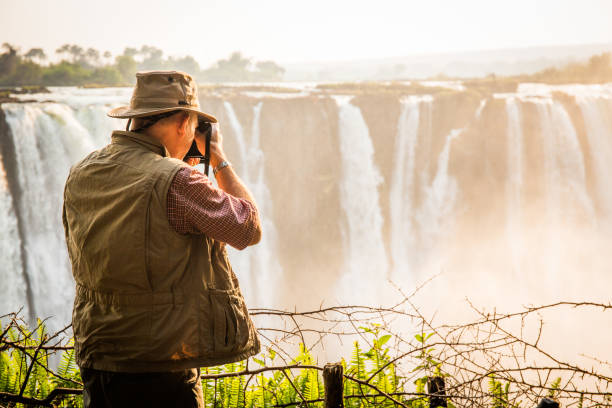 photographer at Sunrise, Victoria Falls, Main Falls, Dry Season stock photo
