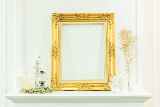 istock Vintage luxurious blank golden wooden frame and decorative things in display shelf with white wall background. 867645620