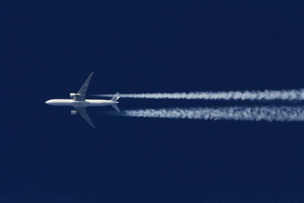 Boeing 777 civil airliner flying on high altitude stock photo