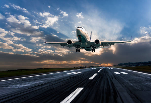 Passenger airplane landing at dusk stock photo