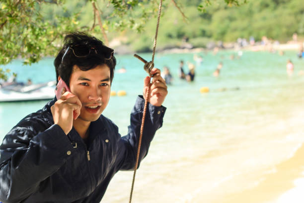 istock Boy phones at the beach 867660804