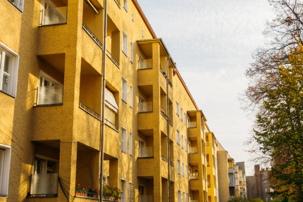 istock yellow apartment houses with autumn trees 867661482