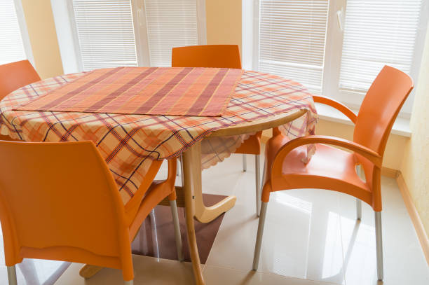 Spacious casual dining area adjoining modern white kitchen.