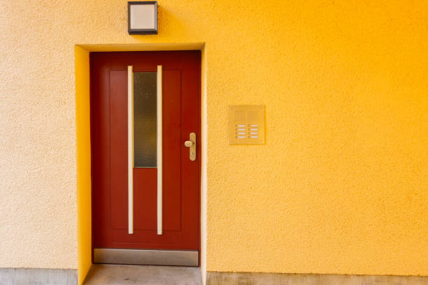 istock yellow facade with red door 867667580