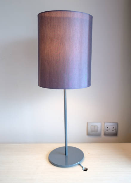 istock Brown desk lamp on wood table 867668128