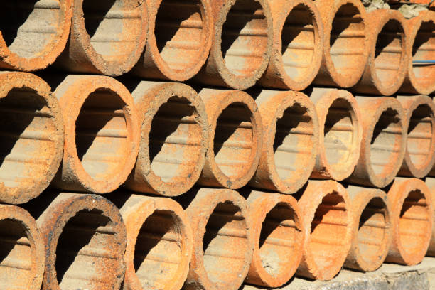 clay drain pipe stacked together in a warehouse