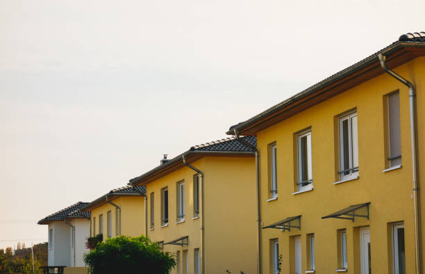 istock yellow townhouses at germany in a row 867671552