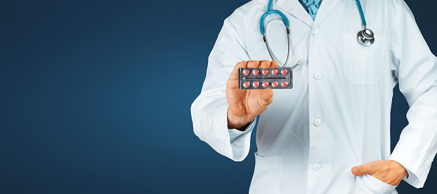 Doctor hand holding Pack of tablet blister. Prescribe medicament, legal drug store