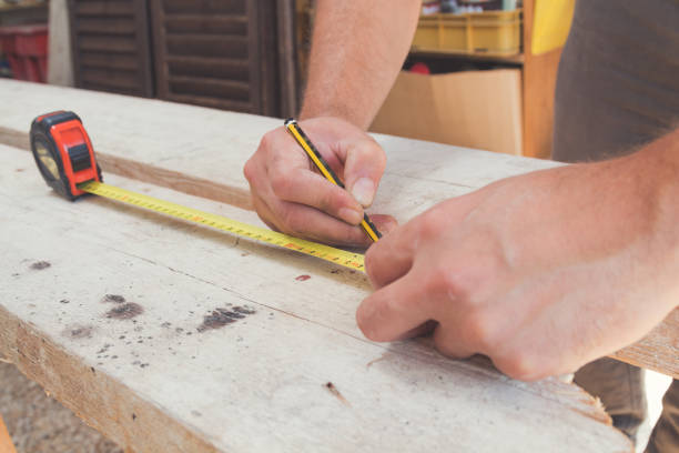 istock Carpenter working on raw wood / boards / plank. 867672288