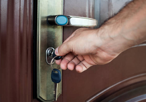 istock Hand unlocking the door with key. 867675070
