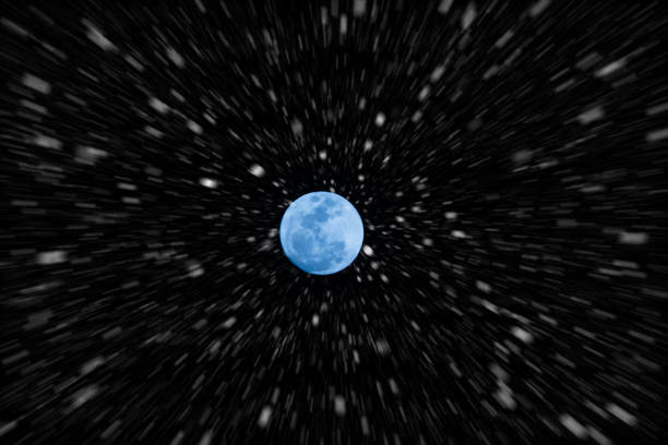 istock Motion snow fall in night sky and blue full moon. 867676202