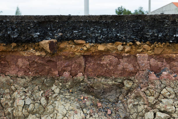 istock The layer of asphalt road with soil and rock. 867678632