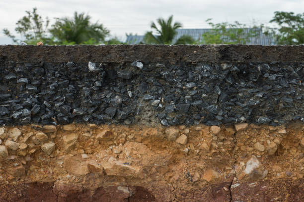 istock The layer of asphalt road with soil and rock. 867678908