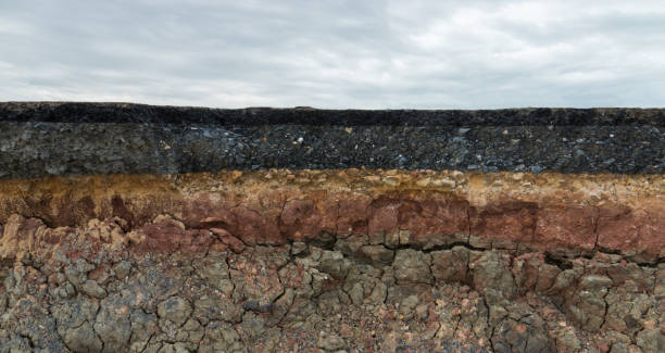 The layer of asphalt road with soil and rock.