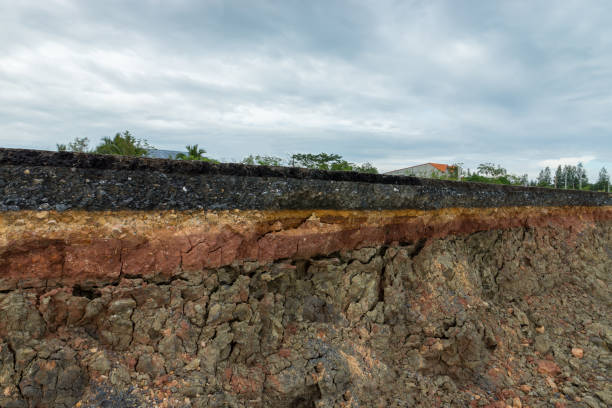 istock The layer of asphalt road with soil and rock. 867678948