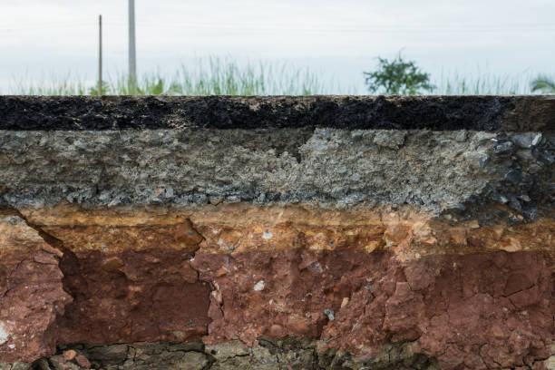 istock The layer of asphalt road with soil and rock. 867679042