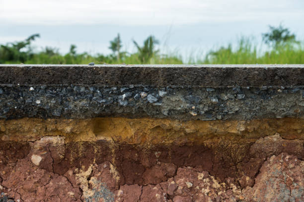 istock The layer of asphalt road with soil and rock. 867679100
