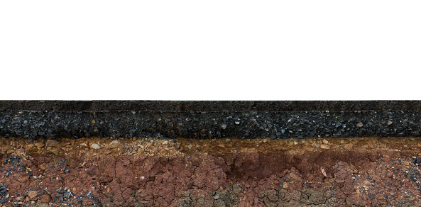 The layer of asphalt road with soil and rock. Un-focus image.